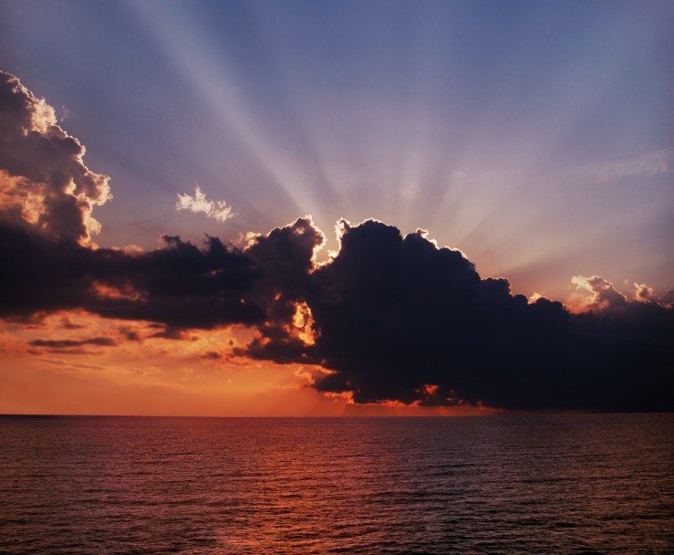 Storm clouds with sun shutterstock_96621118